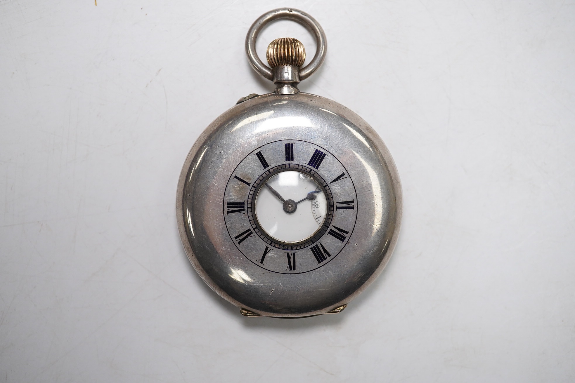 A Swiss 935 white metal half hunter pocket watch, in leather case. Condition - poor to fair